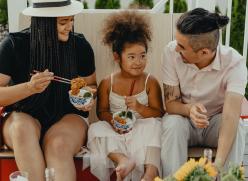Family sitting down to eat.